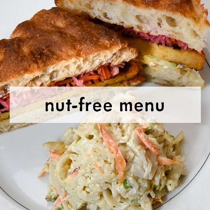 Sandwich with crusty bread and coleslaw on a plate, text overlay reads "nut-free menu." The image conveys a nut-free dining option.
